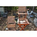 A STAINED PINE FOLDING GARDEN TABLE 76cm wide 60cm deep and a pair of hardwood folding chairs (3)