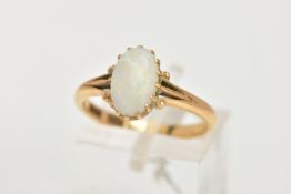 A YELLOW METAL OPAL RING, designed with a sixteen claw set, oval cut opal cabochon, measuring