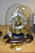 A LATE VICTORIAN BRASS SKELETON CLOCK UNDER A GLASS DOME, the clock with silvered dial with Roman