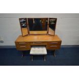 A G-PLAN TEAK DRESSING TABLE, with triple dressing mirror, central drawer with purple baize