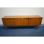 A WRIGHTON TEAK SIDEBOARD, three graduated drawers, fall front flanking a single cupboard door, on