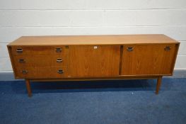 A WRIGHTON TEAK SIDEBOARD, three graduated drawers, fall front flanking a single cupboard door, on