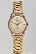 A GENTS 9CT GOLD 'ACCURIST' WRISTWATCH, hand wound movement, round engine turned design, champagne