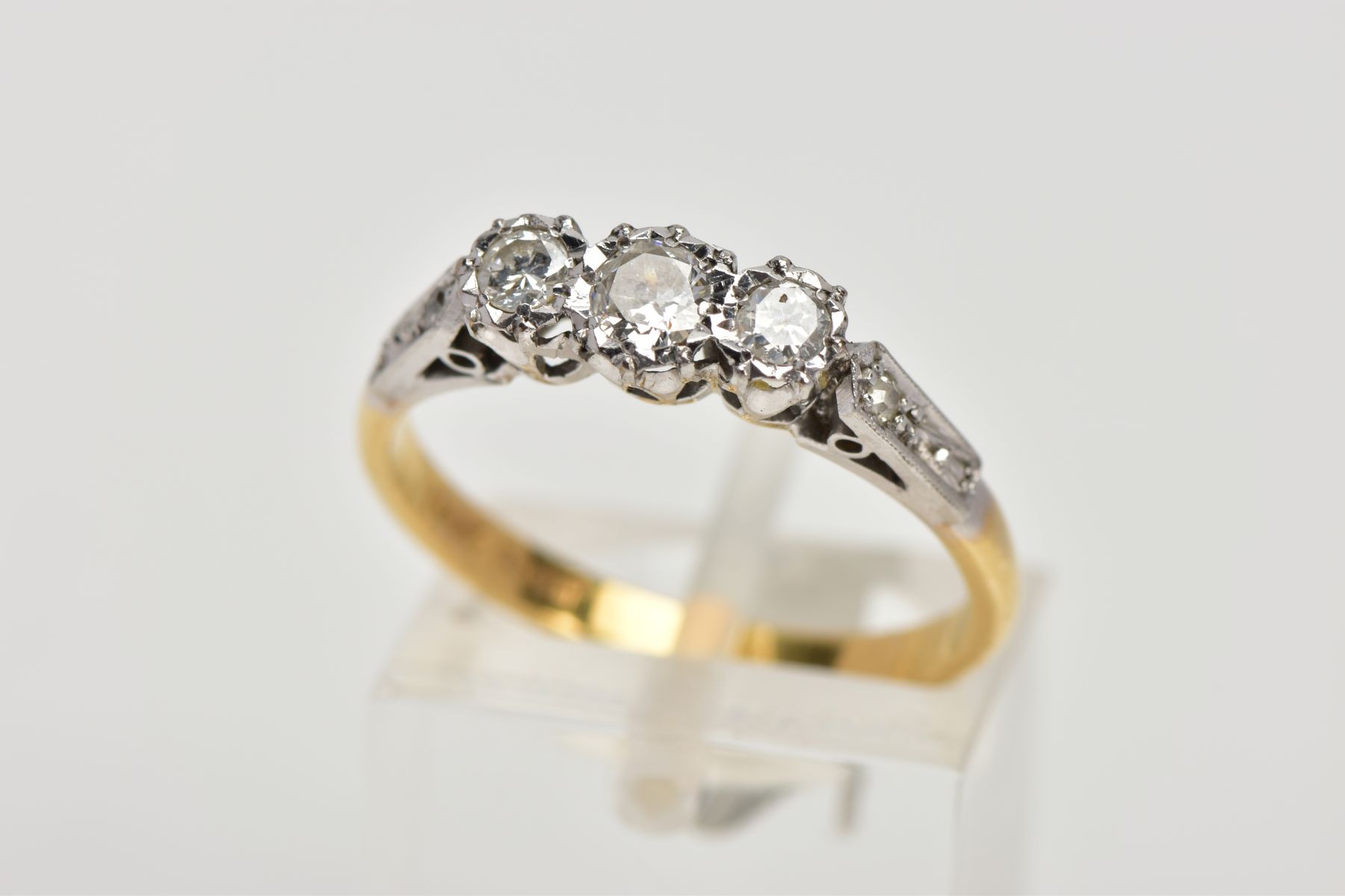 A MID TO LATE 20TH CENTURY THREESTONE DIAMOND RING. Three round brilliant cut diamonds claw set to