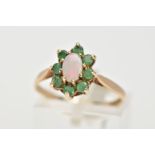 A 9CT GOLD OPAL AND EMERALD CLUSTER RING, the central oval opal cabochon surrounded by claw set