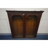 AN EARLY 20TH CENTURY OAK GUN CABINET, loose cornice, with double glazed doors and space for ten