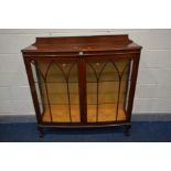 AN EARLY 20TH CENTURY WALNUT TWO DOOR CHINA CABINET, with two glazed shelves, on cabriole legs,
