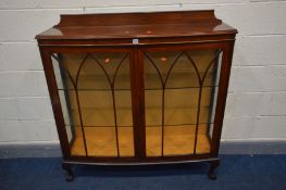 AN EARLY 20TH CENTURY WALNUT TWO DOOR CHINA CABINET, with two glazed shelves, on cabriole legs,