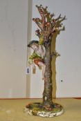 A CAPODIMONTE STYLE ITALIAN PORCELAIN FIGURE OF A BOY TAKING APPLES FROM A TREE, bears signature