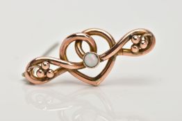 AN EARLY 20TH CENTURY 9CT GOLD OPAL BROOCH, designed as a central scrolling heart leading to outer