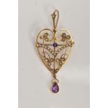 AN EDWARDIAN AMETHYST AND PEARL PENDANT/BROOCH, of an openwork heart shape, set with a circular