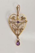 AN EDWARDIAN AMETHYST AND PEARL PENDANT/BROOCH, of an openwork heart shape, set with a circular