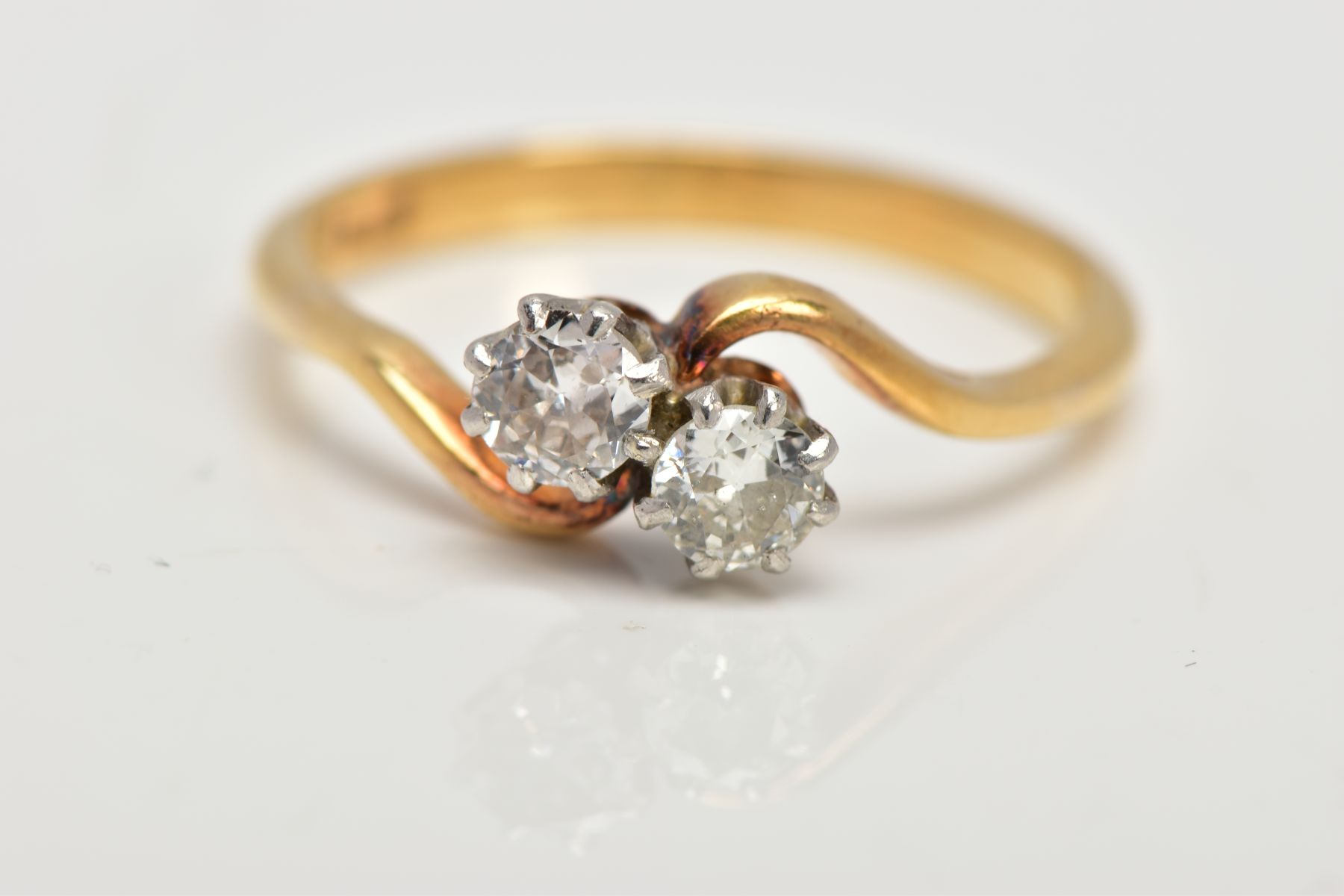 A MID TO LATE 20TH CENTURY TWO STONE CROSSOVER DIAMOND RING. Two early round brilliant cut - Image 5 of 5