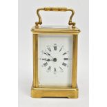 A BRASS CARRIAGE CLOCK, white dial, Roman numerals, blue hands, within a five glass panel