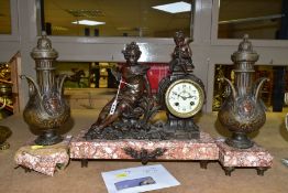AN EARLY TWENTIETH CENTURY BRONZED SPELTER AND MARBLE CLOCK GARNITURE, the figural clock with