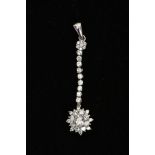 A 9CT WHITE GOLD CUBIC ZIRCONIA PENDANT, designed with a flower cluster, suspended from a line of