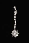 A 9CT WHITE GOLD CUBIC ZIRCONIA PENDANT, designed with a flower cluster, suspended from a line of