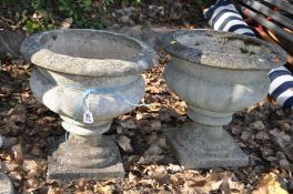 A PAIR OF COMPOSITE BALUSTER GARDEN URNS with fluted detail to sides both 42cm high (some cracks