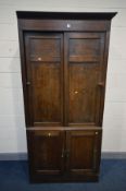 A LATE 19TH/EARLY 20TH CENTURY OAK OFFICE CABINET, the panelled sliding doors enclosing an