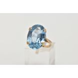 A 9CT GOLD BLUE TOPAZ DRESS RING, designed with a four claw set, oval cut blue topaz, measuring