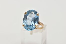 A 9CT GOLD BLUE TOPAZ DRESS RING, designed with a four claw set, oval cut blue topaz, measuring