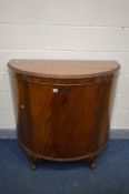 A 20TH CENTURY MAHOGANY DEMI LUNE SINGLE DOOR CABINET, on ball and claw feet, width 110cm x depth