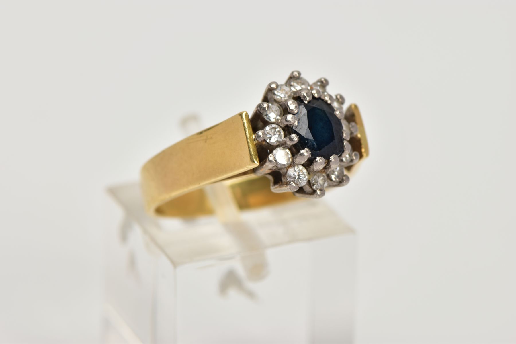 AN 18CT GOLD DIAMOND AND SAPPHIRE CLUSTER RING, centring on an oval cut deep blue sapphire, within a - Image 4 of 4