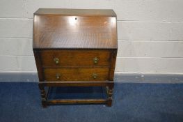 AN EARLY TO MID 20TH CENTURY OAK BUREAU, fall front door enclosing various pigeon holes, above two