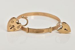 A 9CT GOLD CHILDS BANGLE AND TWO HEART SHAPED CLASPS, the child's bangle with a textured design,