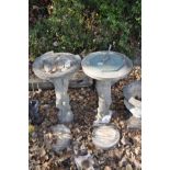 A COMPOSITE SUNDIAL AND A DISTRESSED BIRD BATH with similar Cherub columns and round bases both 70cm