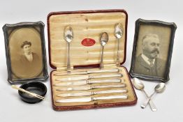 A TRAY OF ASSORTED SILVER ITEMS, to include two silver photo frames, one with a photo of a lady