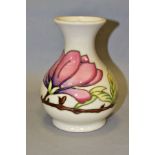 A MOORCROFT POTTERY BALUSTER VASE, pink magnolia on a cream ground, impressed and painted marks to
