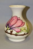 A MOORCROFT POTTERY BALUSTER VASE, pink magnolia on a cream ground, impressed and painted marks to