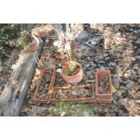 TWO PAIRS OF RECTANGULAR TERRACOTTA PLANTERS 49cm and 32cm wide, a round planter, a cast iron