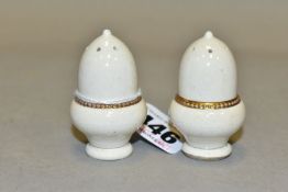 A PAIR OF MOORCROFT POTTERY MINIATURE PEPPERETTES OF ACORN FORM, cream glaze with gilt detail, bases