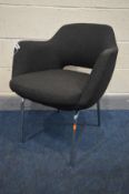 A 1970'S BLACK UPHOLSTERED DESK CHAIR, in the manner of Robin Day, on chrome legs