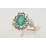 A 9CT GOLD EMERALD AND CUBIC ZIRCONIA CLUSTER RING, designed with a central oval cut emerald, within