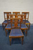 A SET OF SIX OAK GOTHIC CHAPEL CHAIRS with blue leatherette drop in seat pads, and a cross pierced