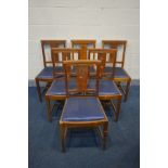 A SET OF SIX OAK GOTHIC CHAPEL CHAIRS with blue leatherette drop in seat pads, and a cross pierced