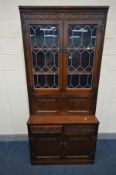 AN OLD CHARM LEAD GLAZED TWO DOOR COCKTAIL CABINET, with two linen fold cupboard doors (no key and