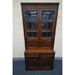 AN OLD CHARM LEAD GLAZED TWO DOOR COCKTAIL CABINET, with two linen fold cupboard doors (no key and