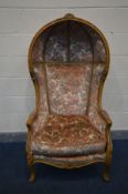 A REPRODUCTION LOUIS XVI STYLE BEECH FRAMED PORTER'S CHAIR, covered in floral upholstery, width 75cm