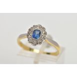 A YELLOW METAL SAPPHIRE AND DIAMOND CLUSTER RING, designed with a central oval cut blue sapphire,