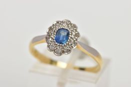 A YELLOW METAL SAPPHIRE AND DIAMOND CLUSTER RING, designed with a central oval cut blue sapphire,