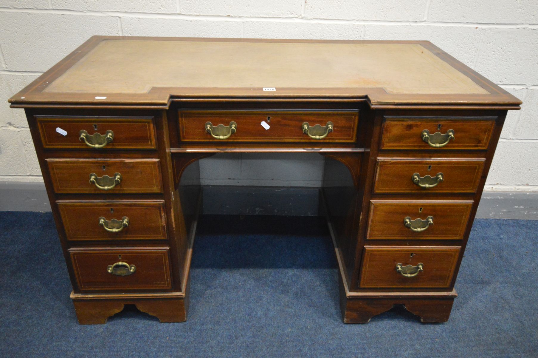 AN EDWARDIAN MAHOGANY AND BOX STRUNG INLAID INVERTED BREAKFRONT KNEEHOLE DESK, with a brown
