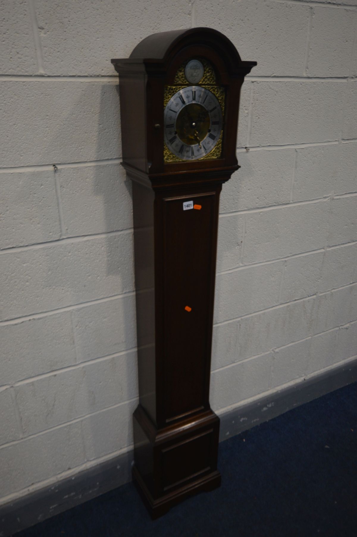 A MAHOGANY EIGHT DAY GRANDDAUGHTER CLOCK, with a brass and silvered dial, tempus fugit label to