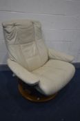 A STRESSLESS CREAM LEATHER RECLINING SWIVEL ARMCHAIR (missing one bolt)