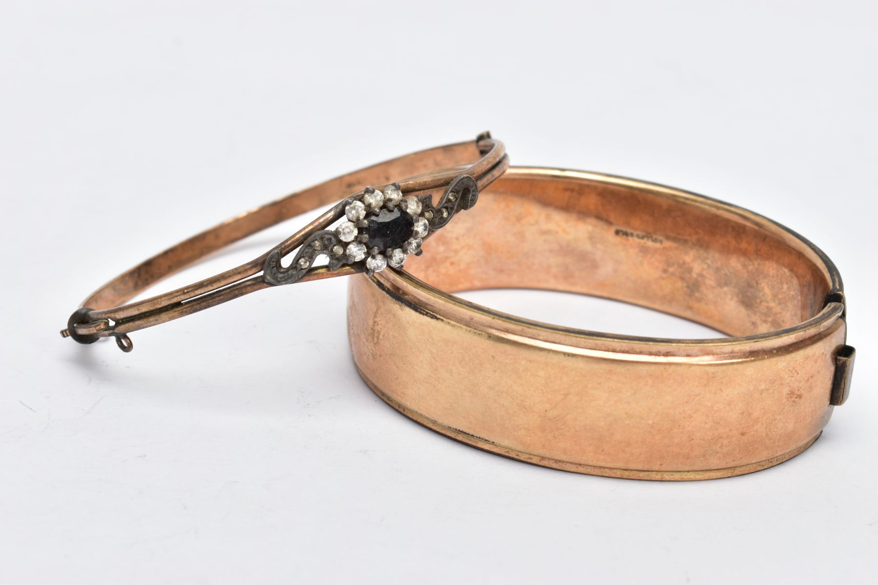 TWO ROLLED GOLD BANGLES, the first a wide bangle, decorated with an engraved floral design, fitted - Image 2 of 4