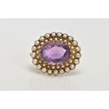 A LATE 19TH EARLY 20TH CENTURY AMETHYST AND SEED PEARL BROOCH, of an oval form, centring on an