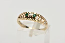 A 9CT GOLD DIAMOND AND EMERALD RING, designed with a central round brilliant cut diamond, flanked